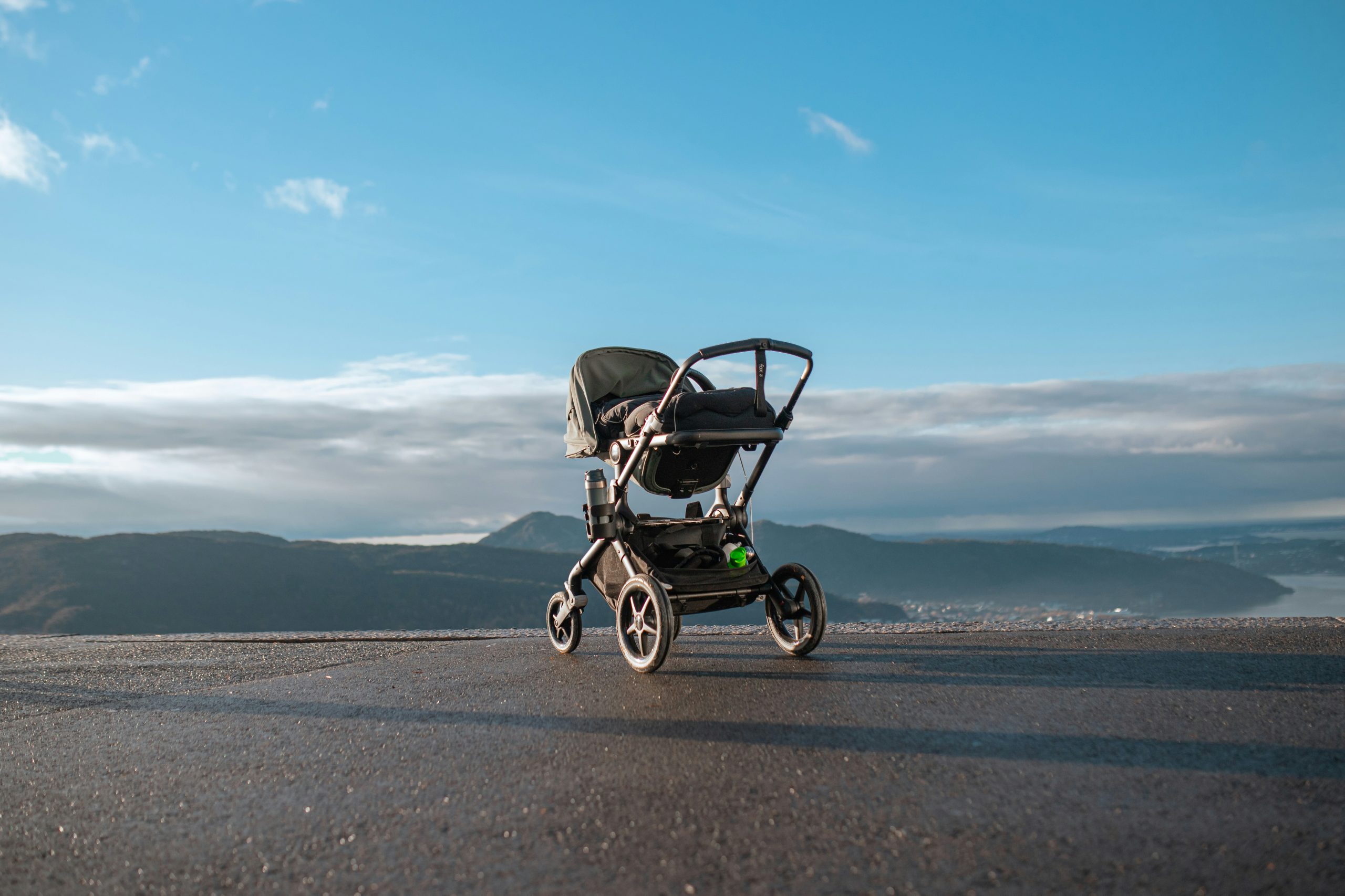 Family walking with stroller on a coastal path